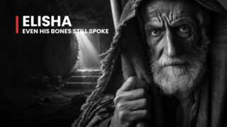 Elisha the aging prophet grips a staff beneath a rough hood, his steady gaze accompanying a story of influence beyond death.
