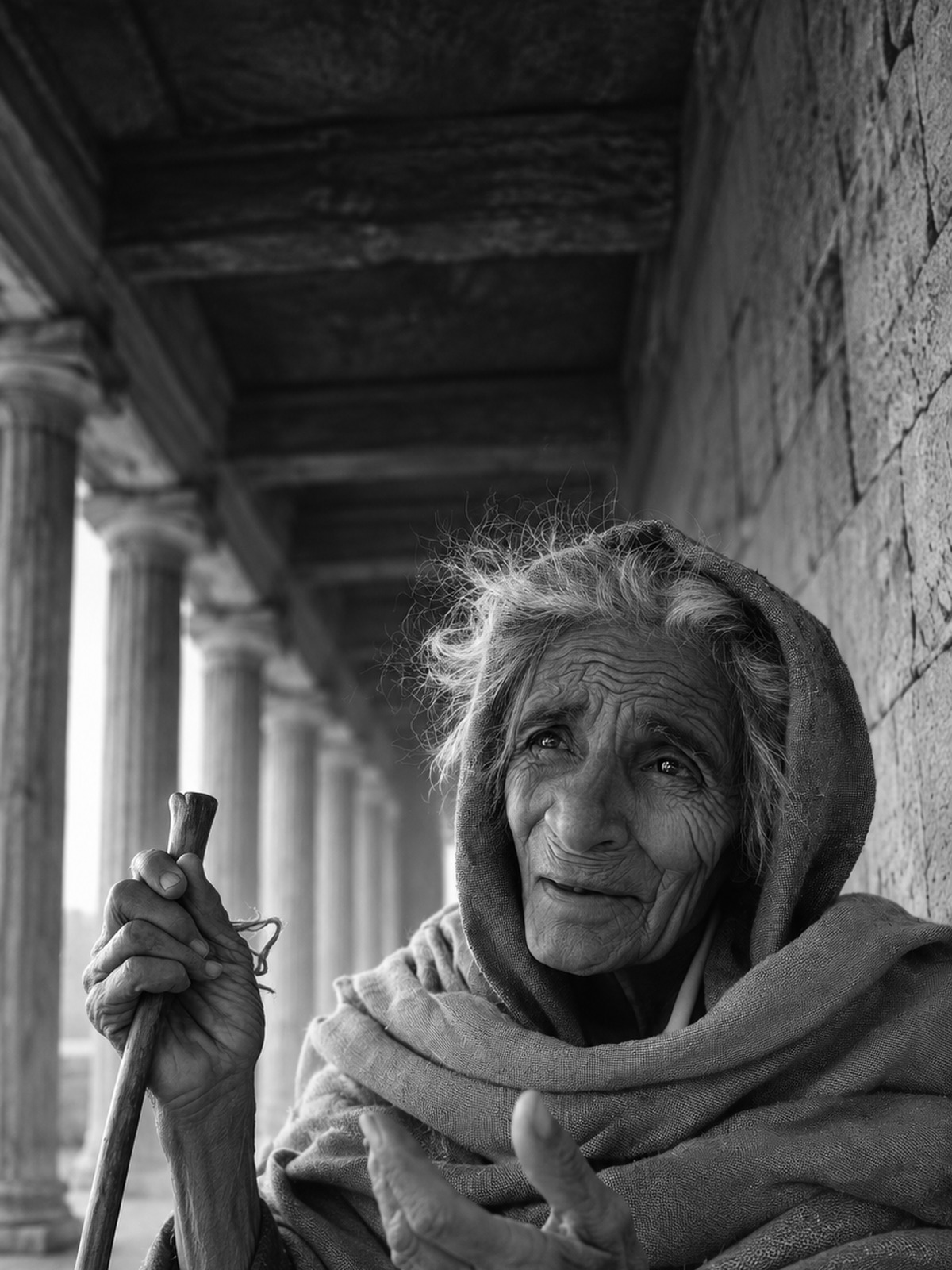 Imagined historical portrait of Anna, an elderly Jewish woman, in a shaded temple walkway.